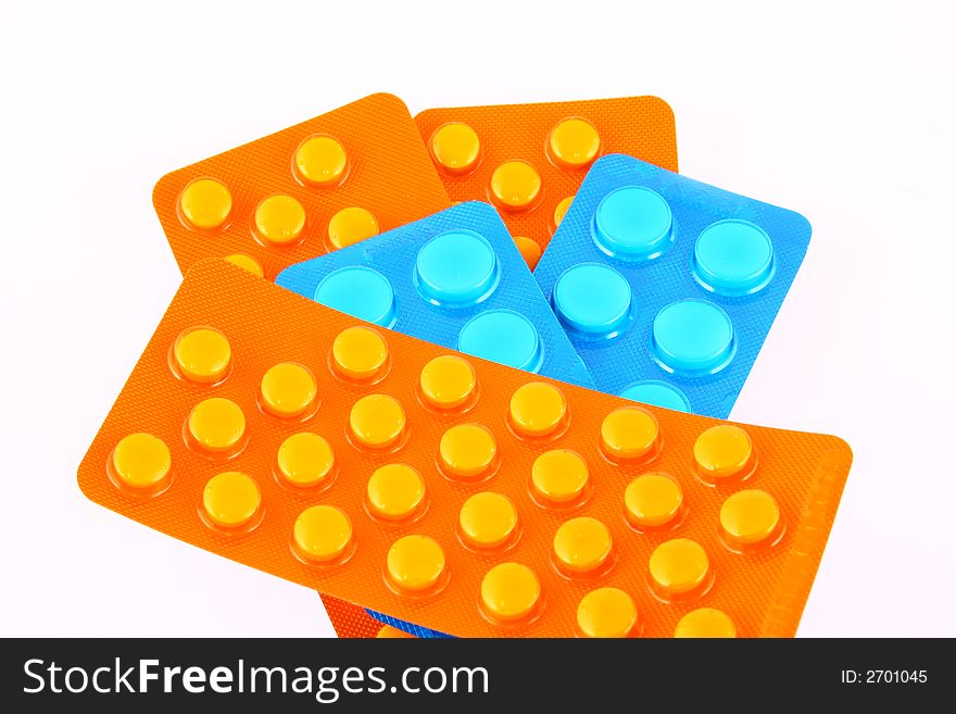 Tablets and vitamin pills in different shapes and colors. Tablets and vitamin pills in different shapes and colors