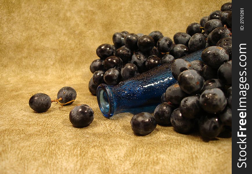 Still life (black grapes and blue bottle)