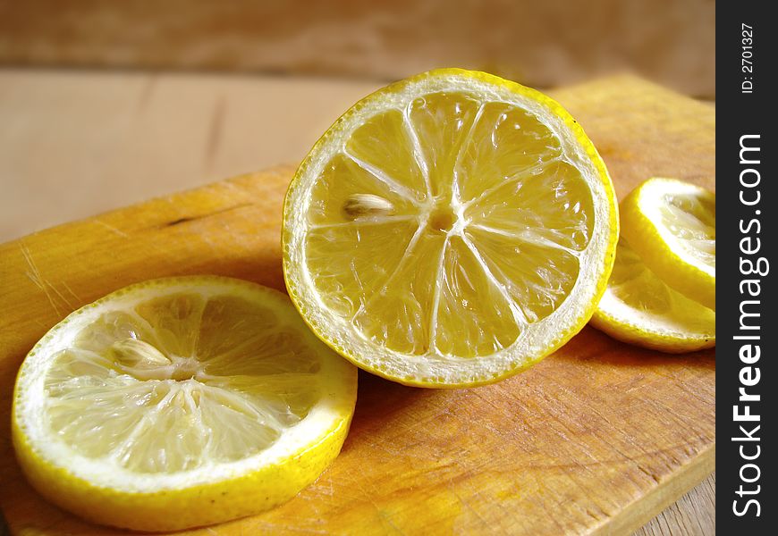 The lemon on a wooden board