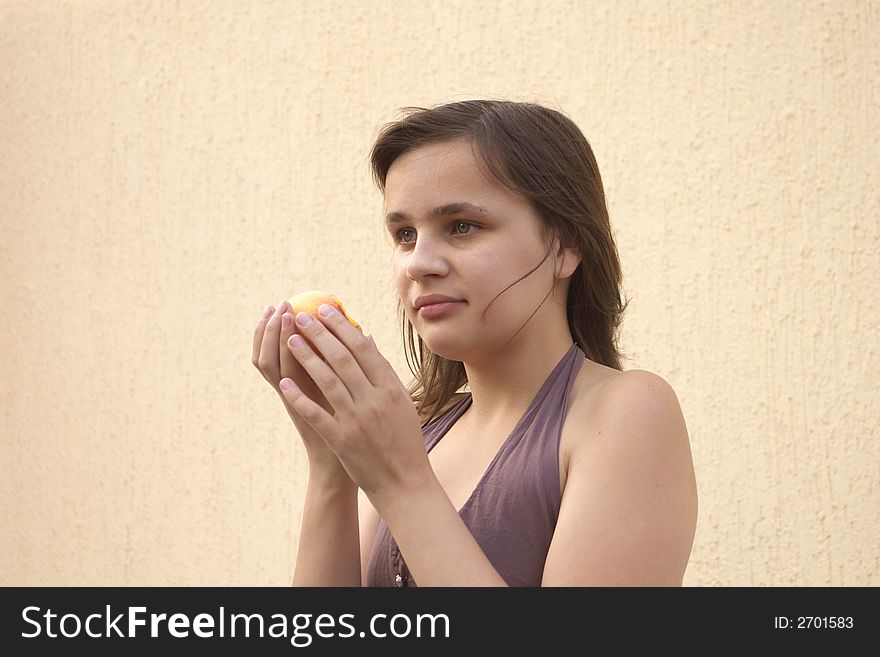 Girl eating big peach