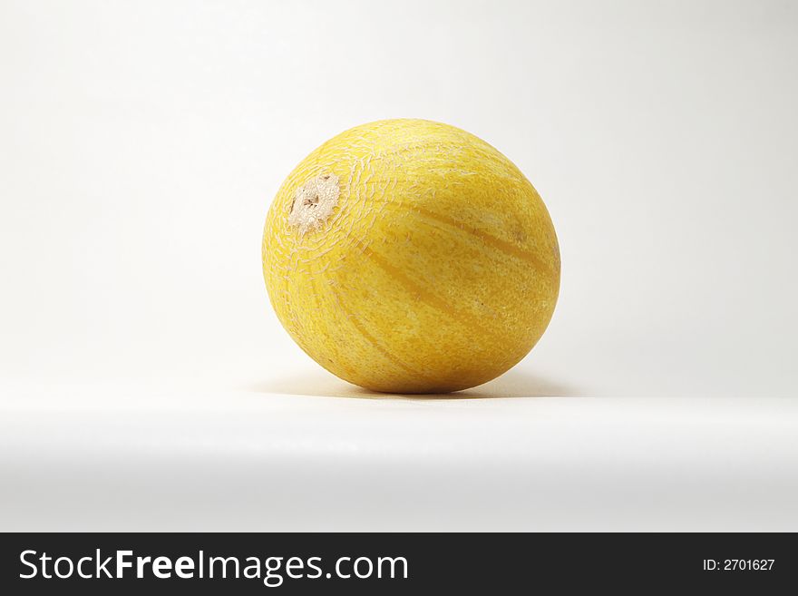 Yellow ripe melon over white