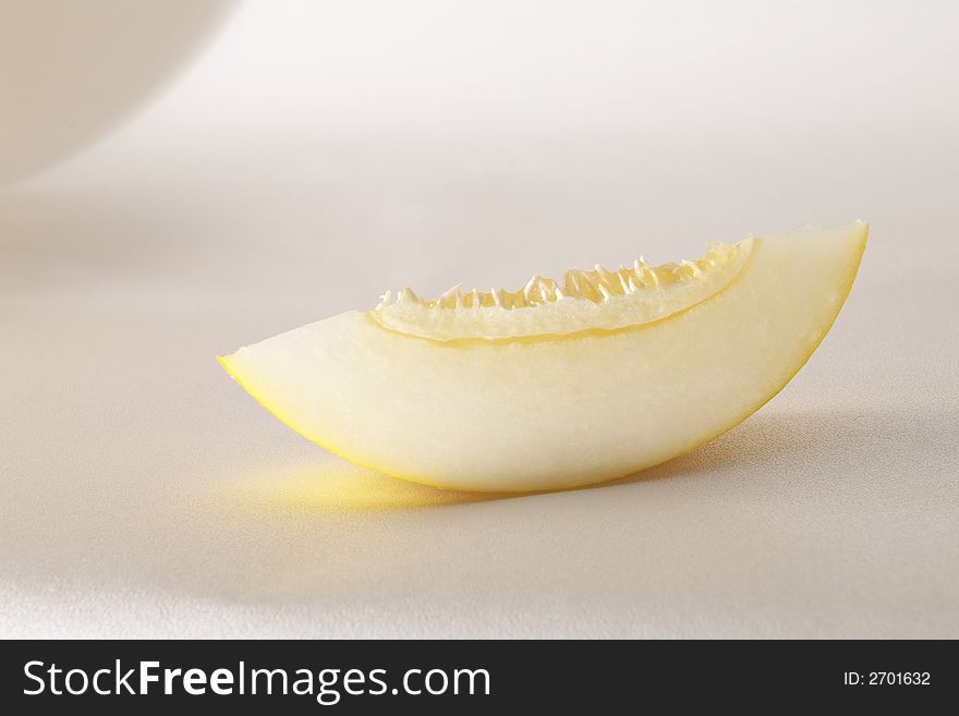 Yellow ripe melon slice over white. Yellow ripe melon slice over white