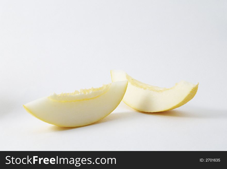 Yellow ripe melon slice over white. Yellow ripe melon slice over white