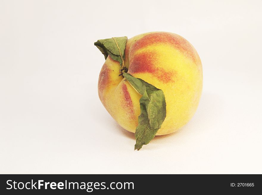 Yellow ripe peach over white