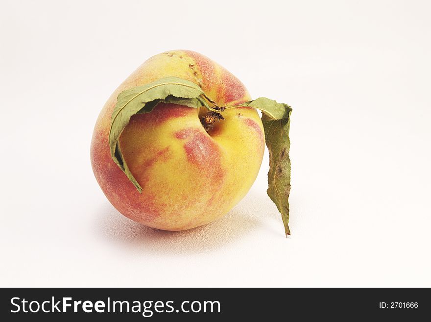 Yellow ripe peach over white