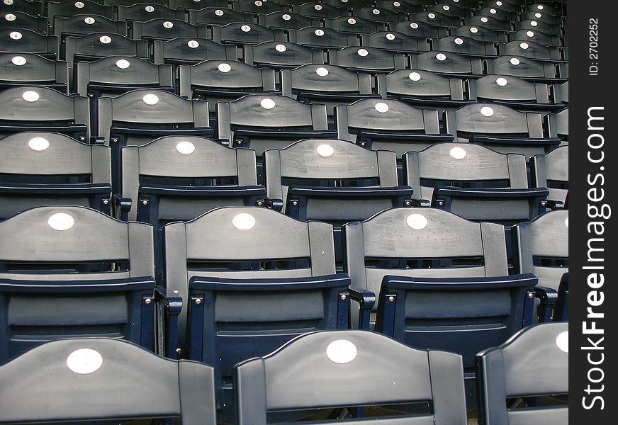 Rows of empty blue seats.