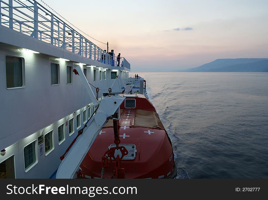 The right side of a moving ferry while sailing on the calm Aegean Sea. The right side of a moving ferry while sailing on the calm Aegean Sea