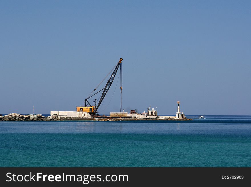 A crane on a pier, while working. A crane on a pier, while working