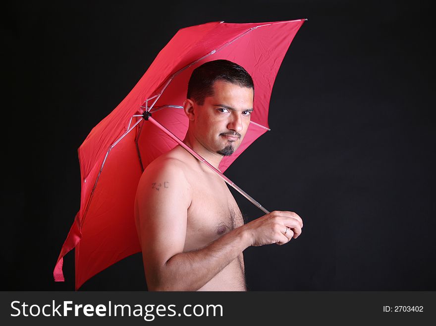 Portrait of a young man with red umbrella