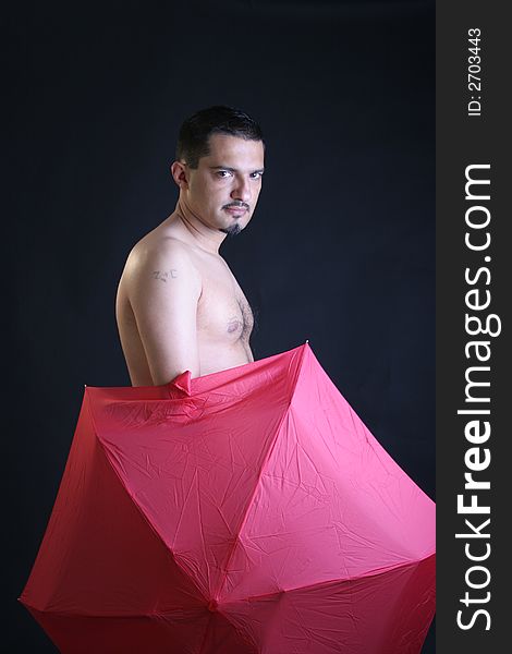 Portrait of a young man with red umbrella