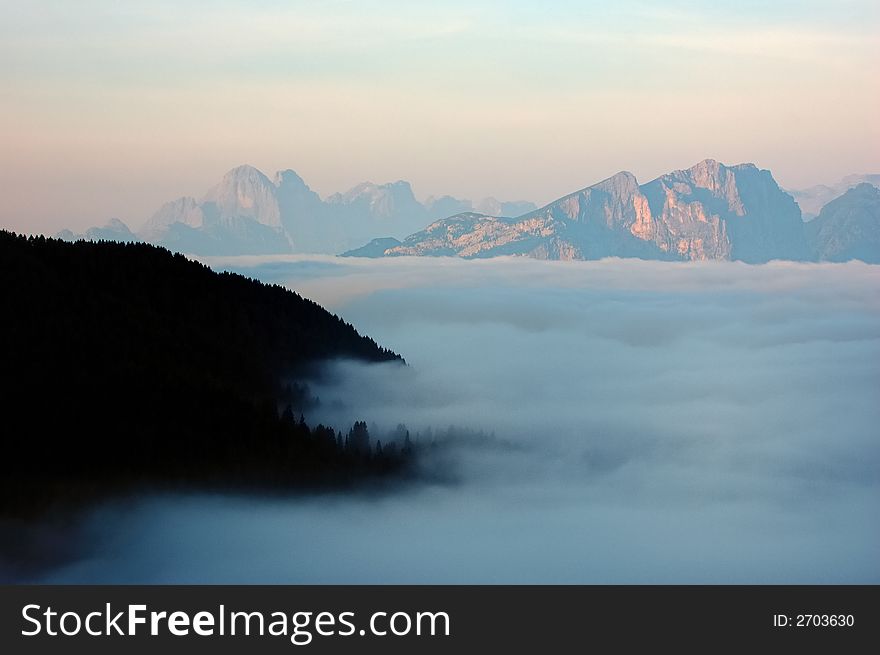 Mountain valley with sea of clouds, Dolomiti, Italy.