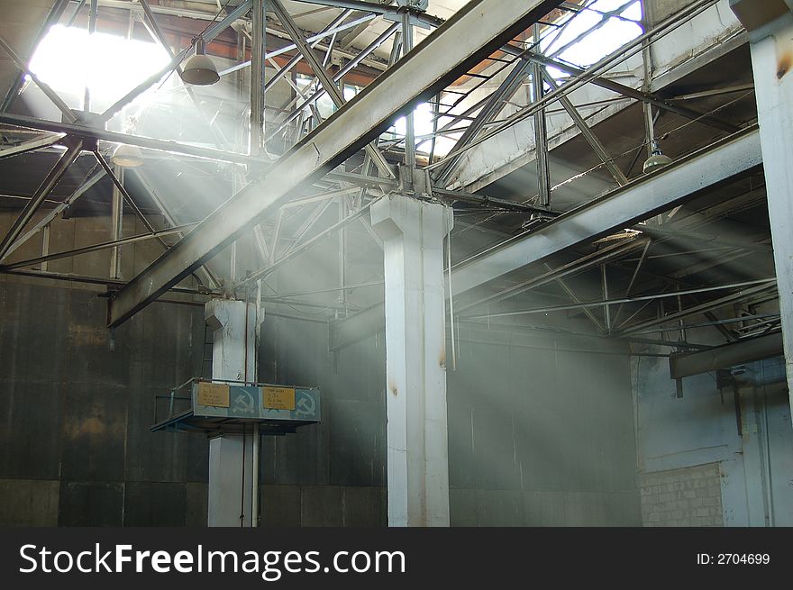 Ray of light across lot of beams at industrial building