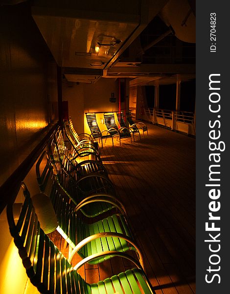 Deck chairs at night on a cruise ship