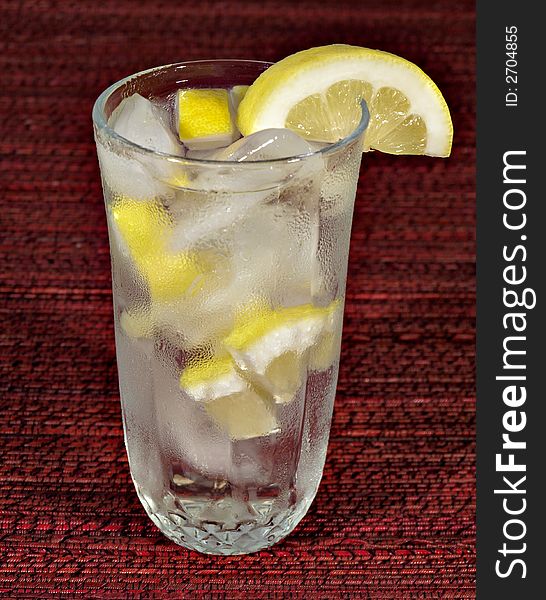 A glass of ice water with lemon. A glass of ice water with lemon