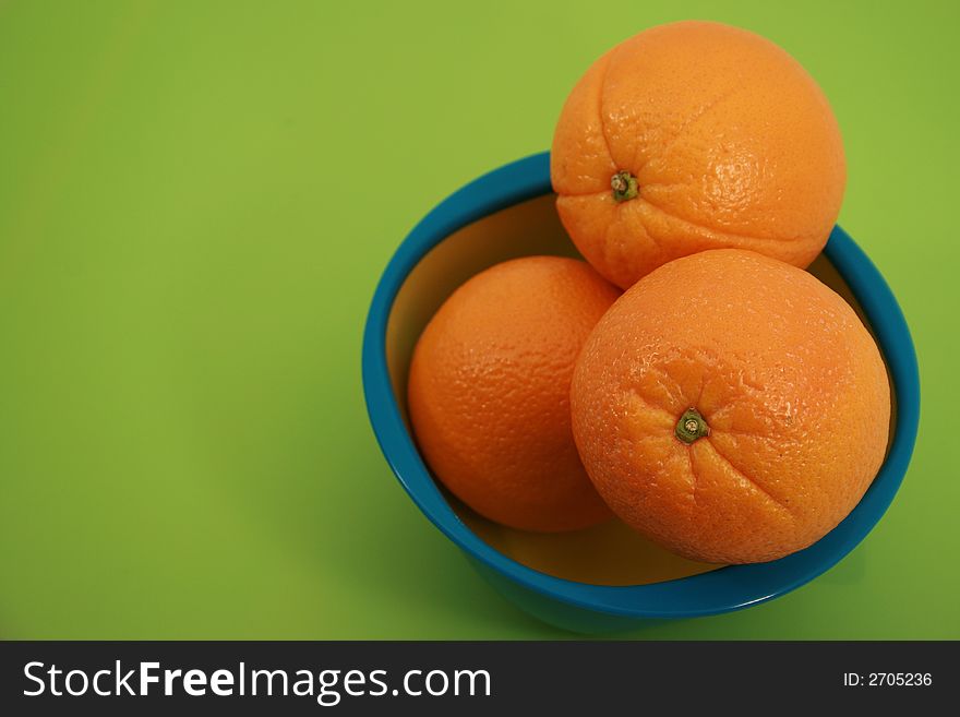 Four Fresh Oranges Full Shot on Green Backgorund