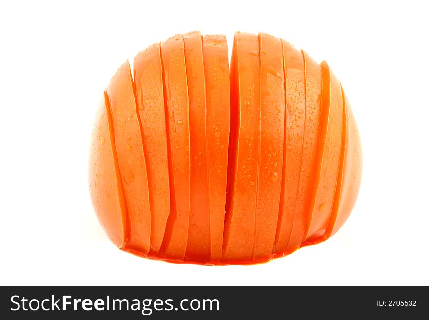 Sliced tomato with dewdrops on a white background