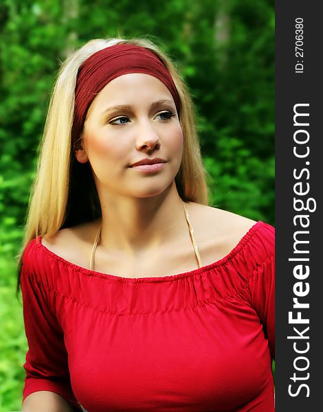 Outdoor beauty portrait of a young smiling woman in nature