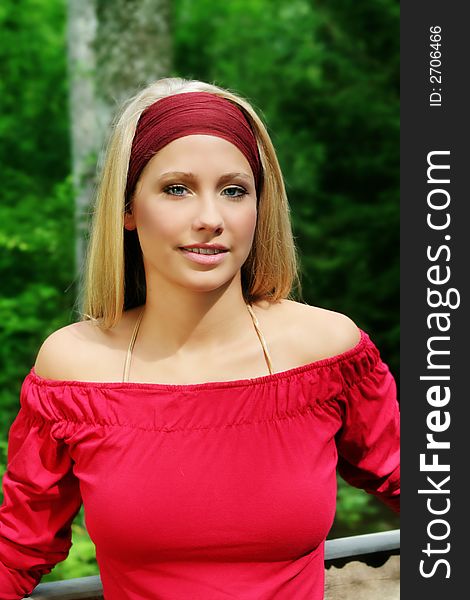 Outdoor beauty portrait of a young smiling woman in nature