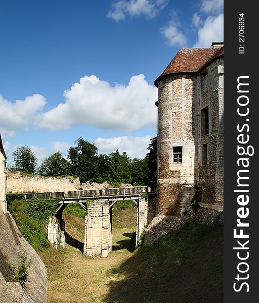 Drawbridge entrance over an empty Moat to a Fortified Chateau in Normandy, France. Drawbridge entrance over an empty Moat to a Fortified Chateau in Normandy, France