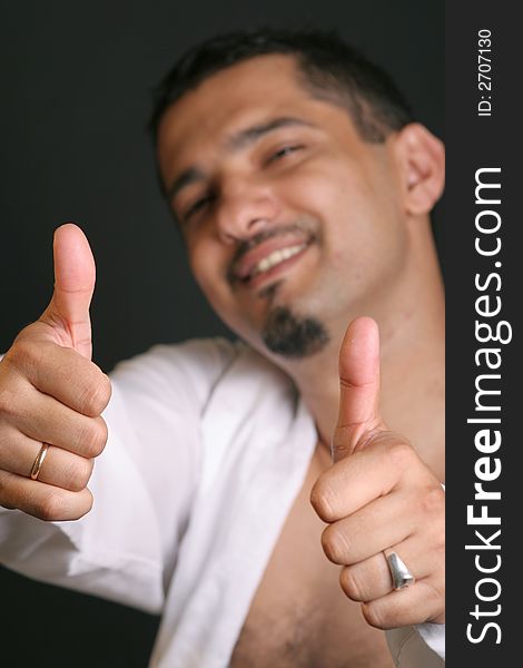 Portrait of a young man with thumb up. Portrait of a young man with thumb up