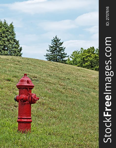 Red fire hydrant on a grassy hillside. Red fire hydrant on a grassy hillside.