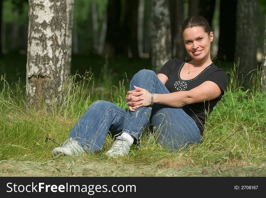 Beautiful lady relaxing outdoors in a park. Beautiful lady relaxing outdoors in a park