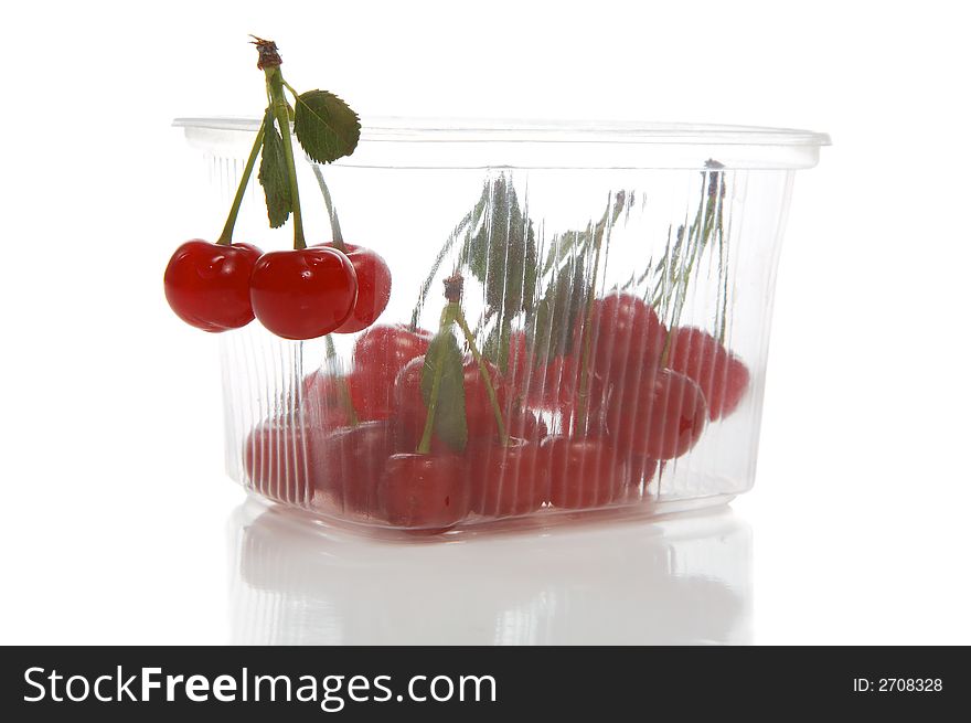 Fresh cherry in transparent packing on a white background