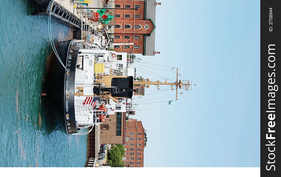 A Coast Guard vessel docked in the harbor, taking on tourists for inspection. A Coast Guard vessel docked in the harbor, taking on tourists for inspection.