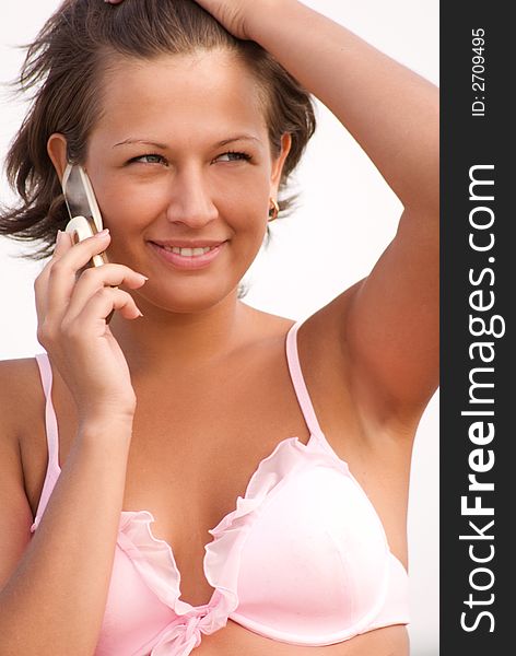 Young voluptious model dressed in bikini talking by phone. Young voluptious model dressed in bikini talking by phone