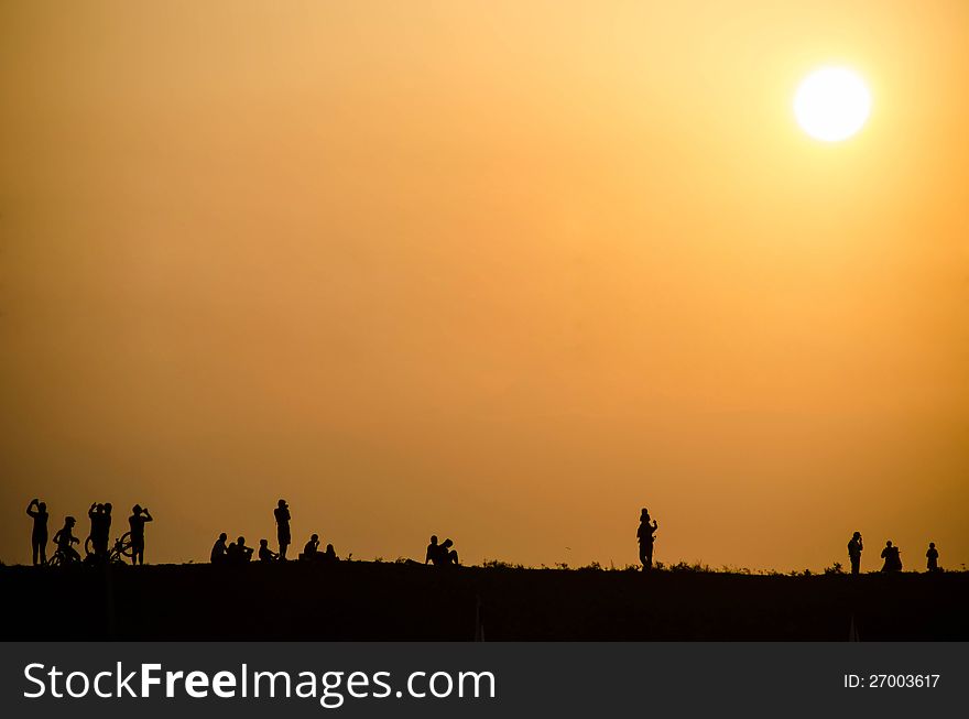 Silhouette of people at sunset on the Silhouette of people at sunset