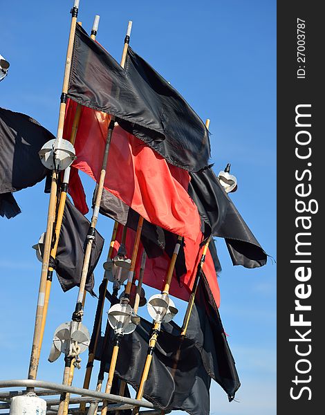 Red and black flags on a fisher boat.