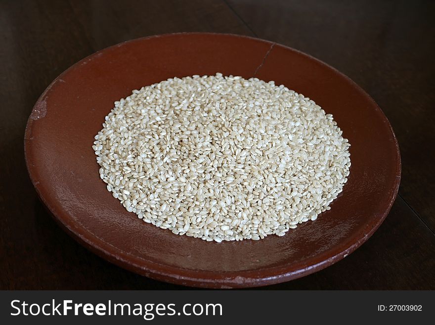 Dry integral rice on old ceramic plate
