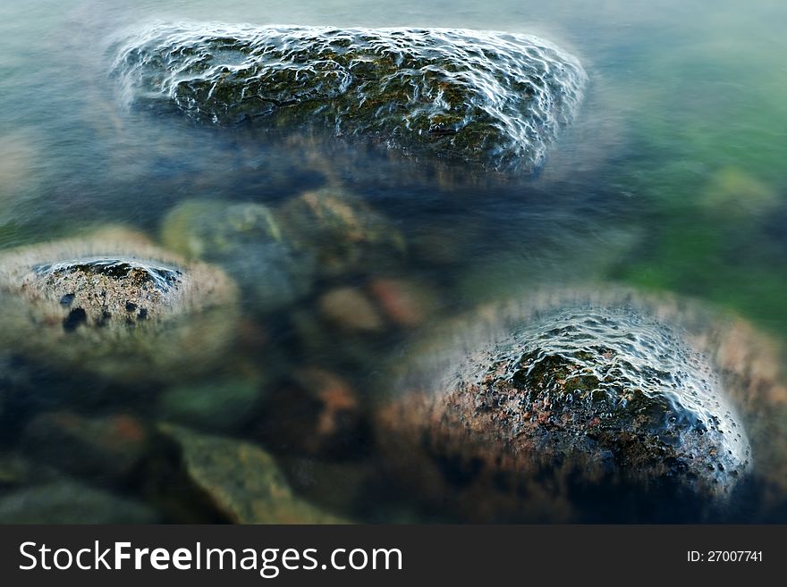 Wet stones in blurred water. Wet stones in blurred water.