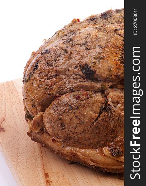 Ripe Roast Pork Tenderloin with Spicy Herbs closeup on Cutting Board