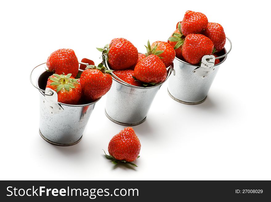 Three Tin Buckets with Perfect Ripe Strawberry in a Row on white background. Three Tin Buckets with Perfect Ripe Strawberry in a Row on white background