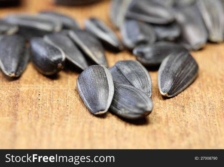 A lot of sunflower seeds on a wooden table