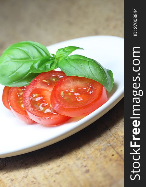 Tomato with basil on dish