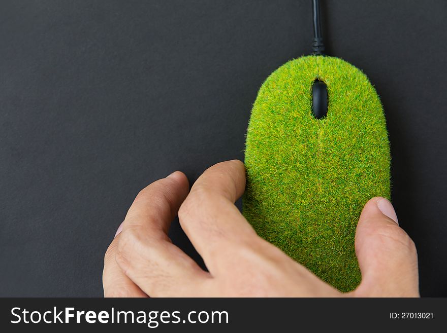 Abstract image of hand holding green mouse
