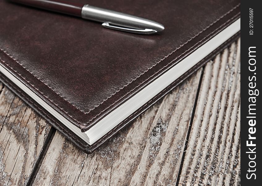 Notebook and pen  on wooden table