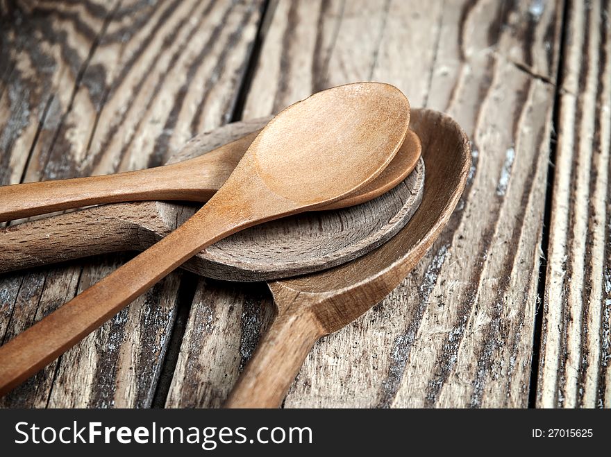 Close up of wooden spoons on wooden background