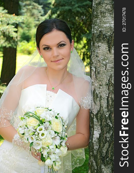 Beautiful bride with a bouquet on nature