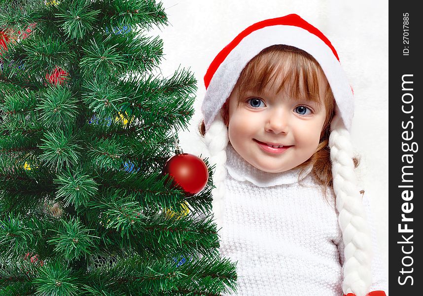 Foto-portrait of a beautiful girl on a background of the Christmas tree. Foto-portrait of a beautiful girl on a background of the Christmas tree