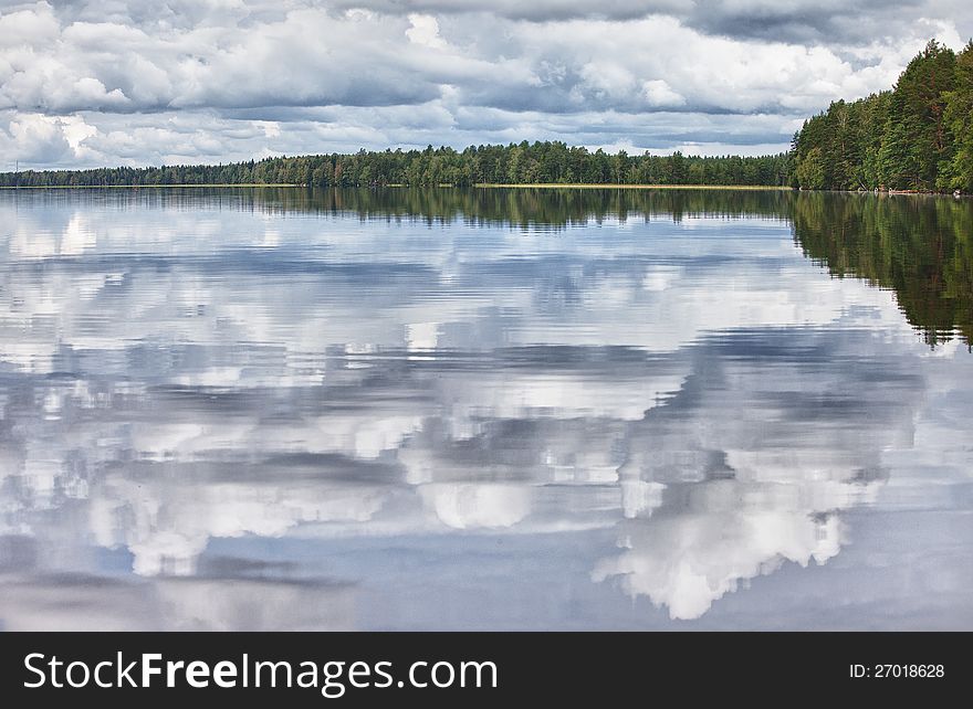Smooth surface of the lakeThe pure lake in an environment of wood thickets. Finland