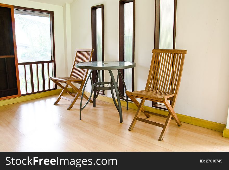 The living room is decorated with wooden chair. The living room is decorated with wooden chair.