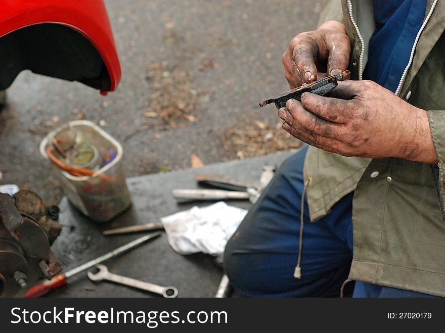 Mechanic Lubricates New Brake Pad With Copper Oil.