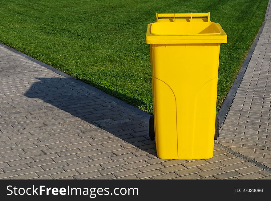 Big yellow recycling container in the park