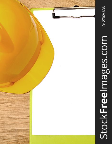 Yellow hard hat and clipboard. You can put your design on the clipboard. Yellow hard hat and clipboard. You can put your design on the clipboard