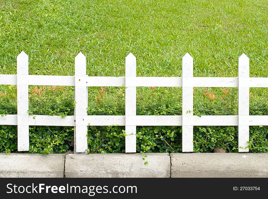 Wooden fence on a green meadow. Wooden fence on a green meadow