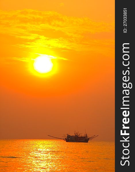 Picture of fishing boat in sunset silhouette.