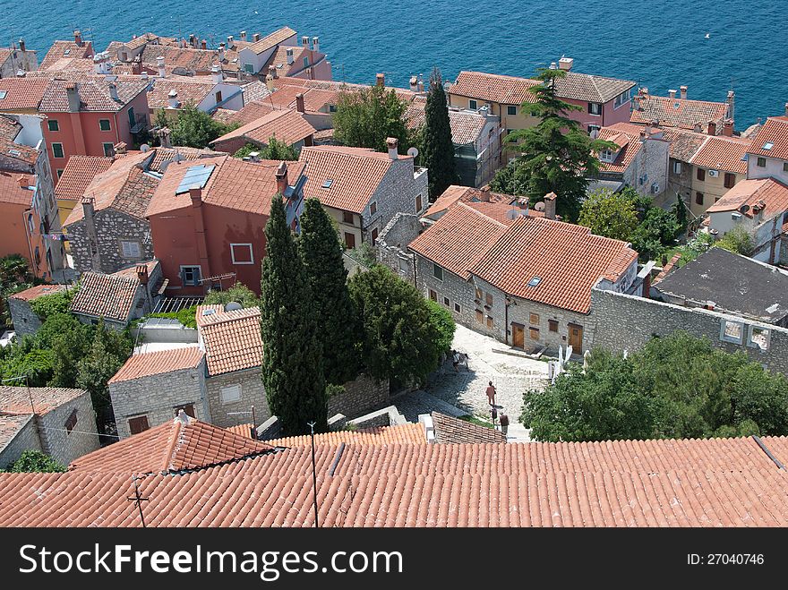 Old mediaeval village streets and red Mediterranean roof in Croatia (Rovinj) with sea in background, seen form bell church of saint Evfemija. Old mediaeval village streets and red Mediterranean roof in Croatia (Rovinj) with sea in background, seen form bell church of saint Evfemija